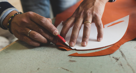 Shoemaker cutting leather