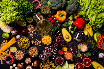 Trend set of fresh vegetables and fruits on black background. Different colorful fresh vegan food. Flat lay.