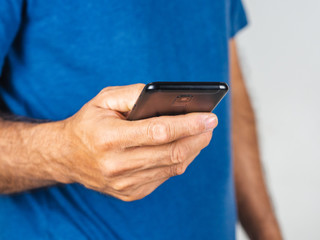 Closeup of young man using smartphone isolated on a white background