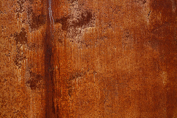 Rusty yellow-red textured metal surface. The texture of the metal sheet is prone to oxidation and corrosion. Textured background in grunge Style
