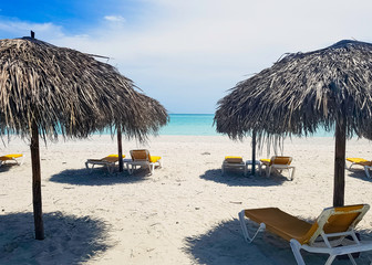Cuban beach, umbrellas and sunbeds with Atlantic Ocean in background - Varadero, Cuba