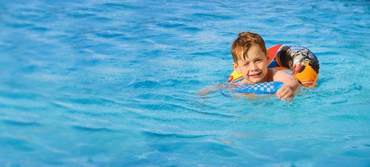 Happy child in a swimming pool