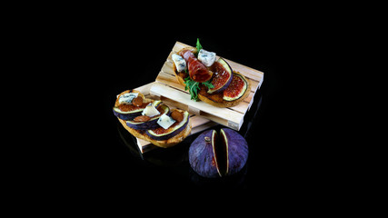Toasted whole wheat bread with figs, cheese, thyme, honey served on wooden rustic board. Healthy food concept. Top view