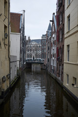 Amsterdam, Netherlands - February 22, 2019: View of a small canal near Bloemenmarkt