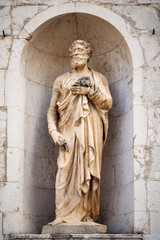 ancient stone Saint Peter statue at Assisi Marche Italy