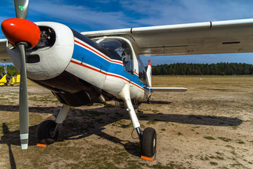 Small hstorian sports aircraft with white-blue paint shortly before take-off