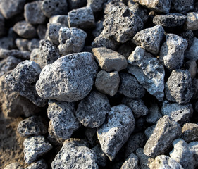 Stones on the edge of the asphalt road