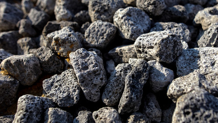 Stones on the edge of the asphalt road