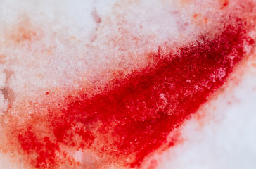 Red blood on white snow as a background