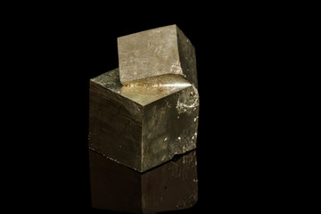 Macro mineral stone Pyrite on a black background