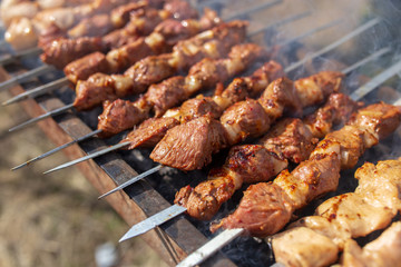 Shish kebab on skewers is fried on a brazier