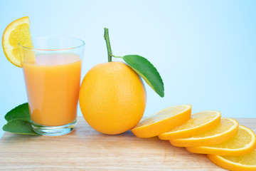 Orange juice and oranges with leaves