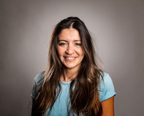 Fototapeta premium portrait of happy woman smiling on a gray background