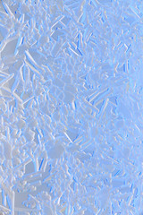 Snow patterns on glass as an abstract background