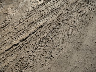 Background or concept, traces of cars on liquid mud, construction, road repair