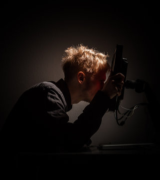 Young Man Looking Very Closely At A Computer Screen