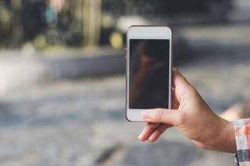 hipster woman using mobile phone touching screen at outdoor with hands typing smart phone texting messaging lifestyle working app device technology internet social data online concept vintage style.