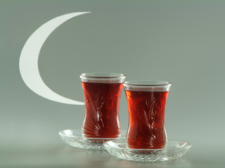 Karkade tea in pear-shaped armudu glasses and white crescent