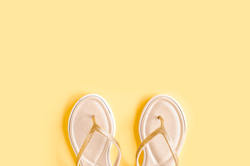 Women's summer sandal isolated on yellow background. Flat lay, top view minimal concept.
