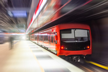 Fototapeta na wymiar Passing underground train to the tunnel on the subway platform, motion blur.