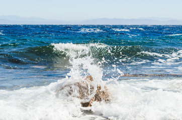 waves and splashes of sea surf and stones on the seashore in Egypt Dahab South Sinai
