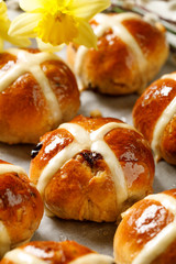 Hot cross buns,freshly baked hot cross buns on white parchment paper. Traditional easter food