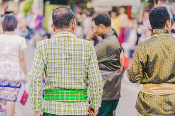 Obraz premium Happiness villagers dressed in beautiful local costumes join the parade to celebrate Songkran Festival at Ban Nong Khao in Kanchanaburi, Thailand.
