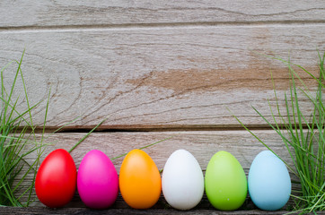 Easter eggs in grass against blurred green background. Spring holidays concept