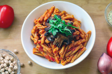 Vegan & Gluten free chickpea pasta with tomato sauce. topped with mushrooms and arugula. 