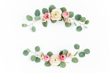 Wreath frame made of branches eucalyptus, pink ranunculus, roses and leaves isolated on white background. lay flat, top view