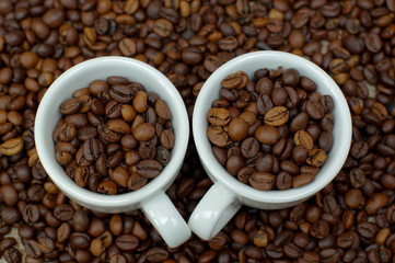 Cup of coffee full of coffee beans. Сoffee cup and coffee beans. Cup full of coffee beans on the cloth sack