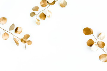 Borders of the frame of gold branches, eucalyptus leaves on a white background. flat layout, top view