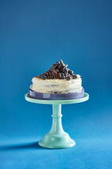 Blueberry cake on a blue tray on a blue background