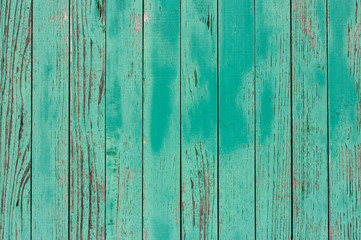 Old and weathered wooden green background with copy space. Cyan wooden background  with empty space for your text.  green wooden fence (palisade) - Vintage style. Striped surface with aqua color.