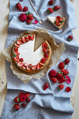 Cheesecake with strawerries on gray fabric