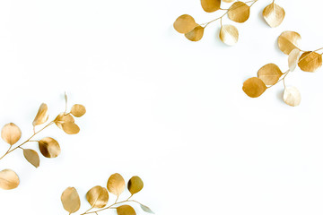 Borders of the frame of gold branches, eucalyptus leaves on a white background. flat layout, top view