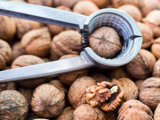 Nutcracker on brown nuts background, Natural walnut pattern texture