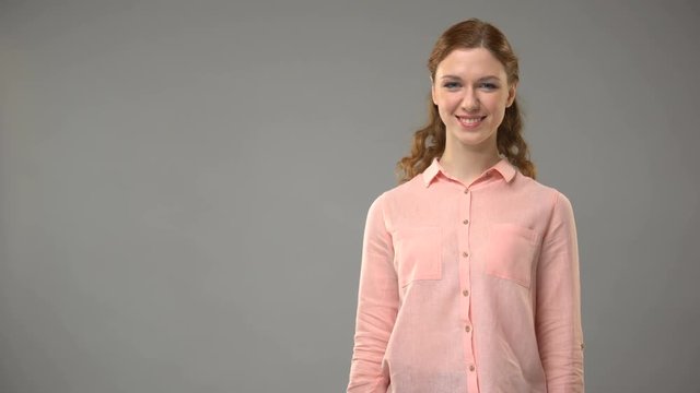 Female asking what is your name in sign language, showing words in asl lesson