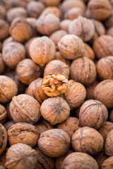 Walnut kernels on natural walnut pattern background, Raw bio walnuts texture, top view