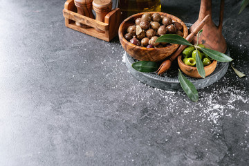 Green olives in wooden bowl