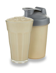 A glass of vanilla milkshake and shaker