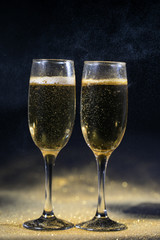 glasses of champagne on black background