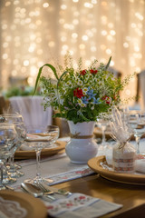 wedding table with floral arrangement prepared for reception, wedding, birthday or event centerpiece 