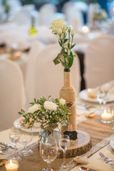 wedding table with floral arrangement prepared for reception, wedding, birthday or event centerpiece 