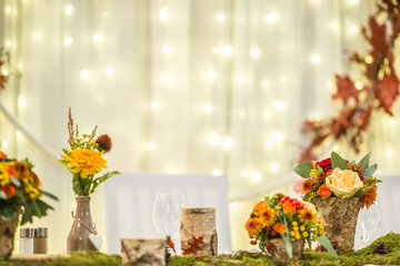 wedding table with floral arrangement prepared for reception, wedding, birthday or event centerpiece 