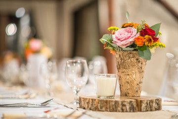 wedding table with floral arrangement prepared for reception, wedding, birthday or event centerpiece 