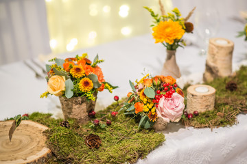 wedding table with floral arrangement prepared for reception, wedding, birthday or event centerpiece 