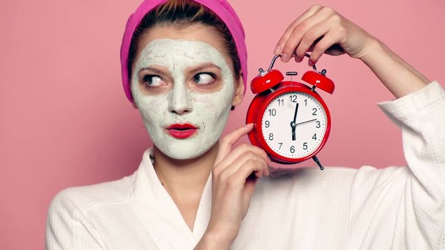 Closeup of attractive young female model applying cosmetic mud on skin. Spa concept.Wellness and Spa concept. Woman wearing face mask. Beautiful girl with cosmetic mask on her face.