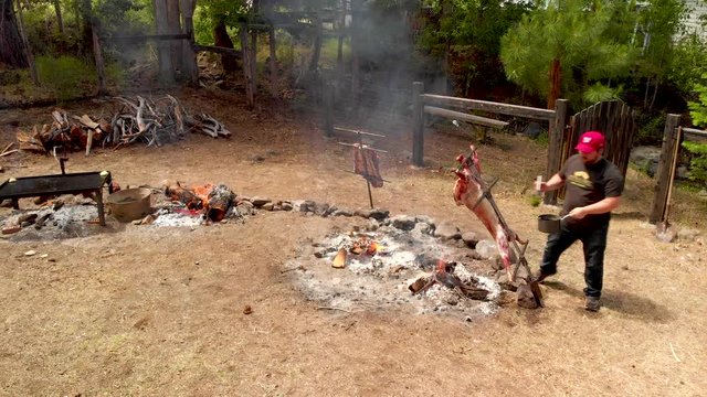 Man cooking lamb in argentinian BBQ style