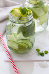 glasses with a refreshing drink, mint, lime and cucumber on a white background close up.